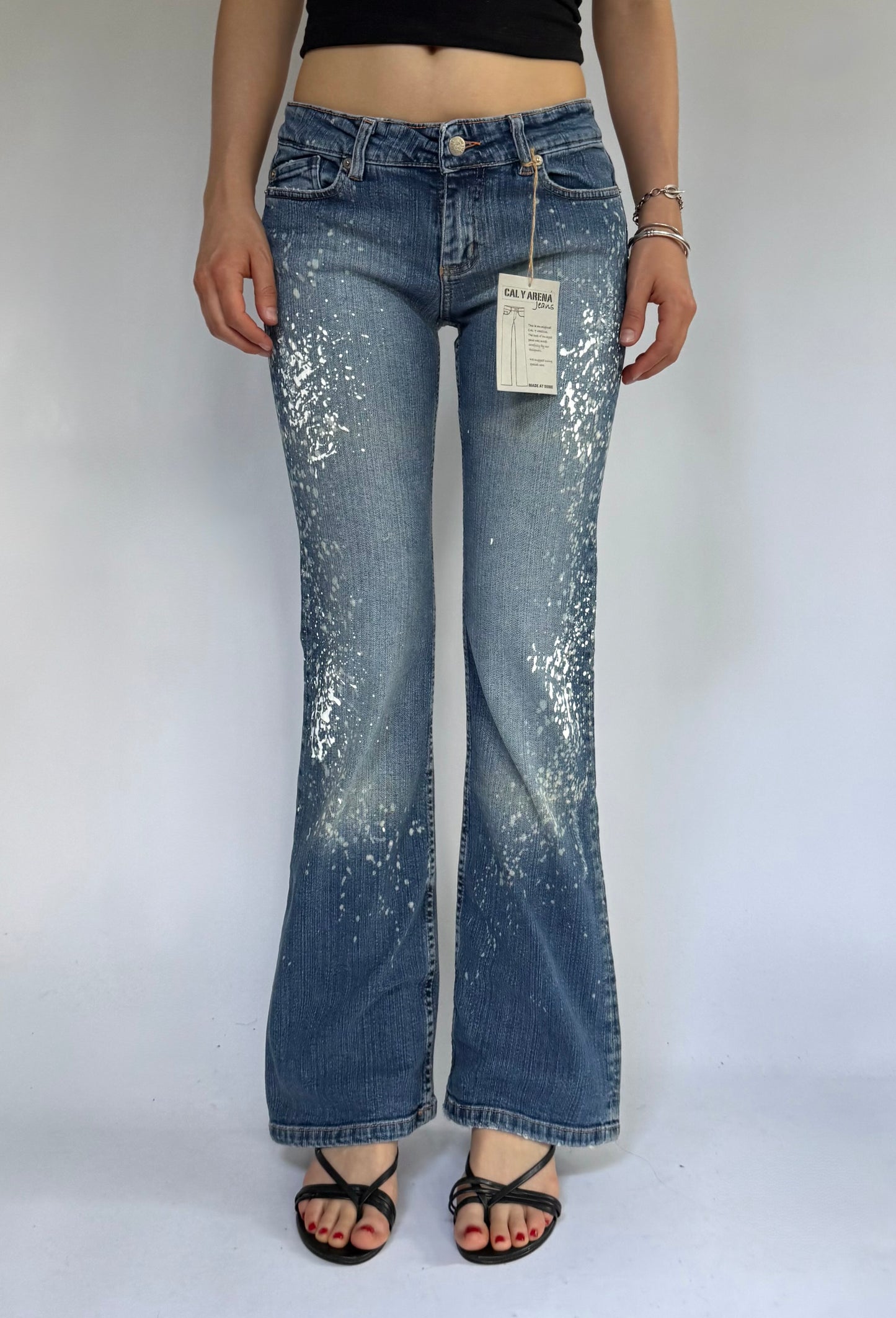 Y2K deadstock CALY ARENA low rise flared jeans with paint splatter and acid wash design