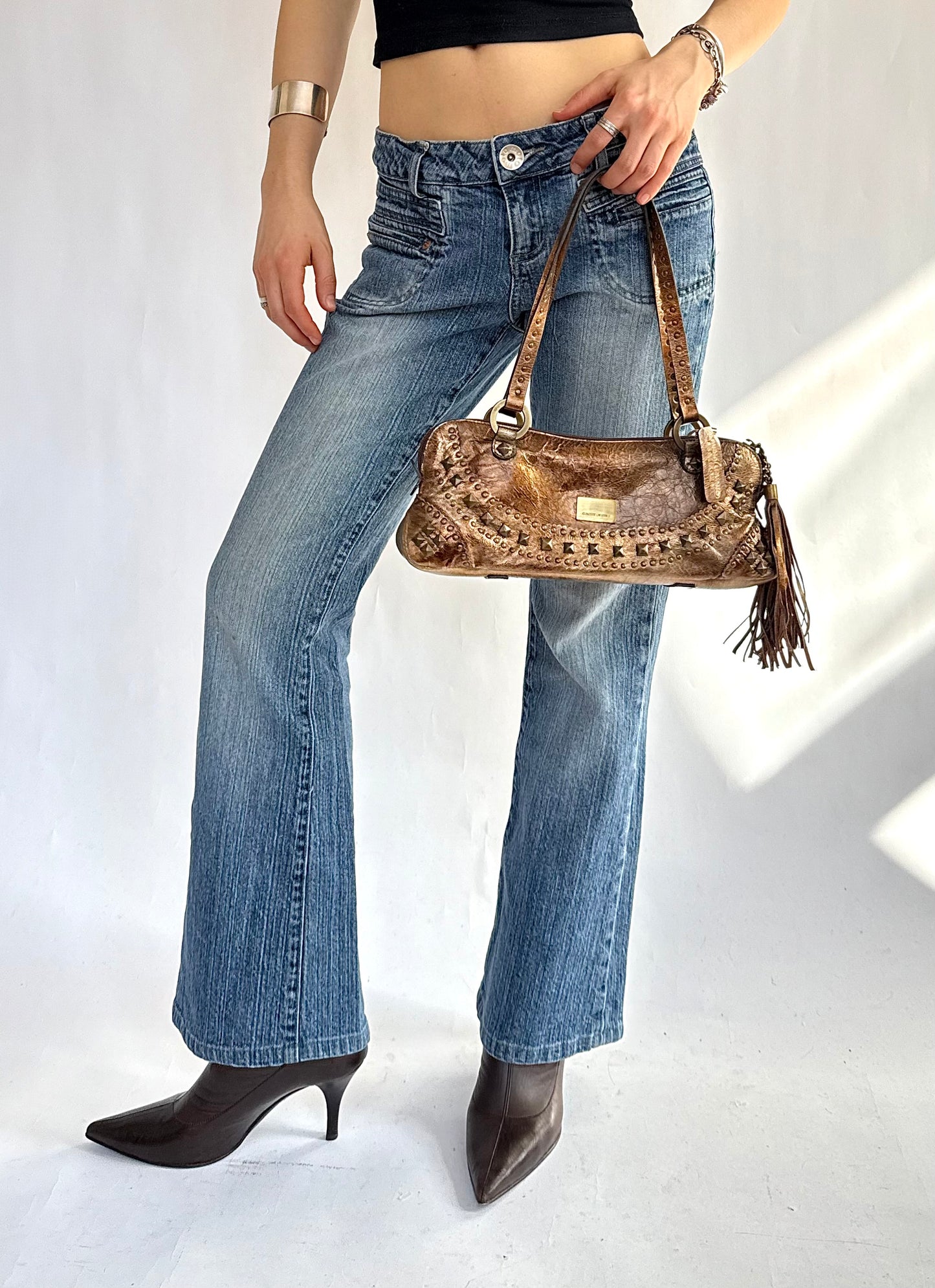 Y2K leather shoulder bag with fringe detail and studs by Claudia Levine