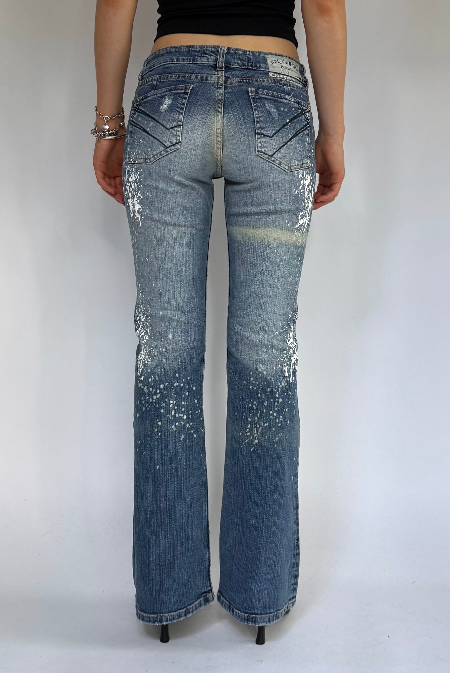 Y2K deadstock CALY ARENA low rise flared jeans with paint splatter and acid wash design